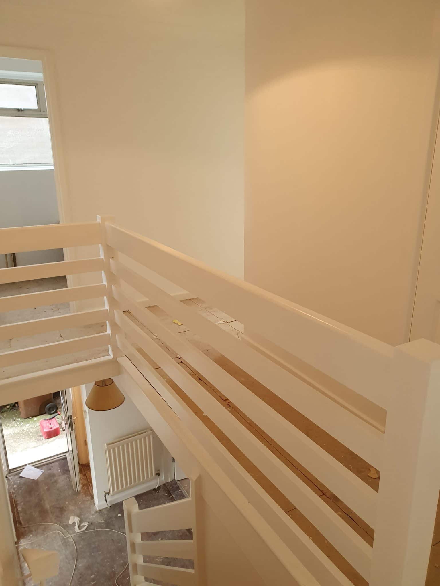 Cream painted stairwell with a white painted balustrade