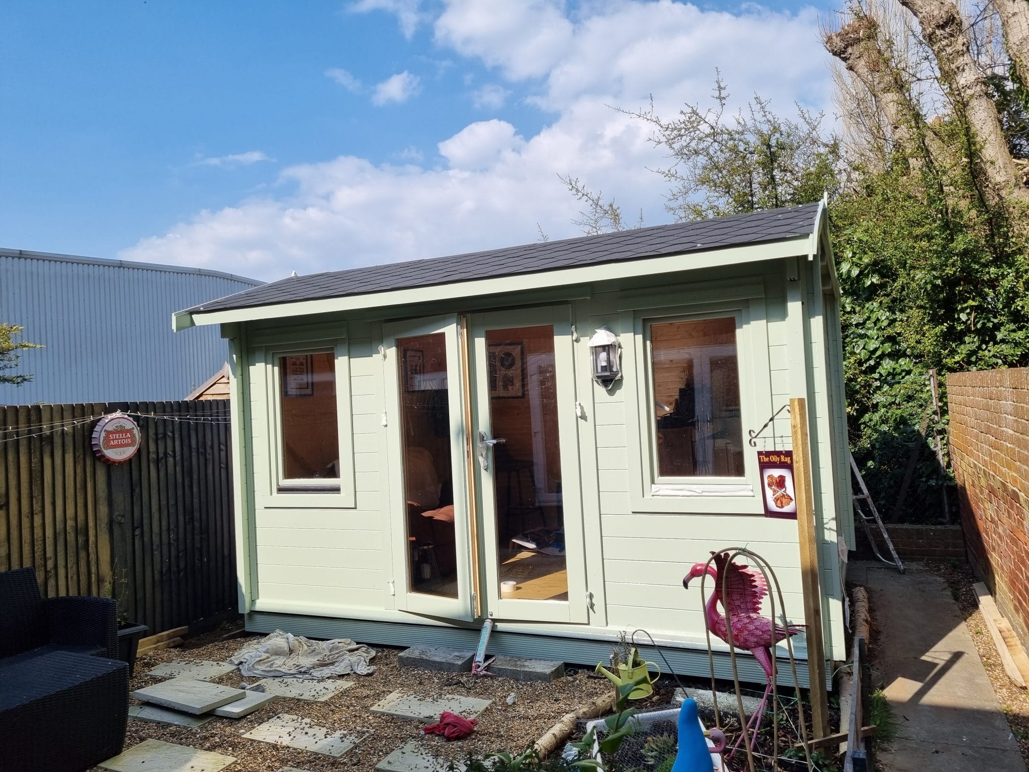 Sage green painted garden room with glazed double doors