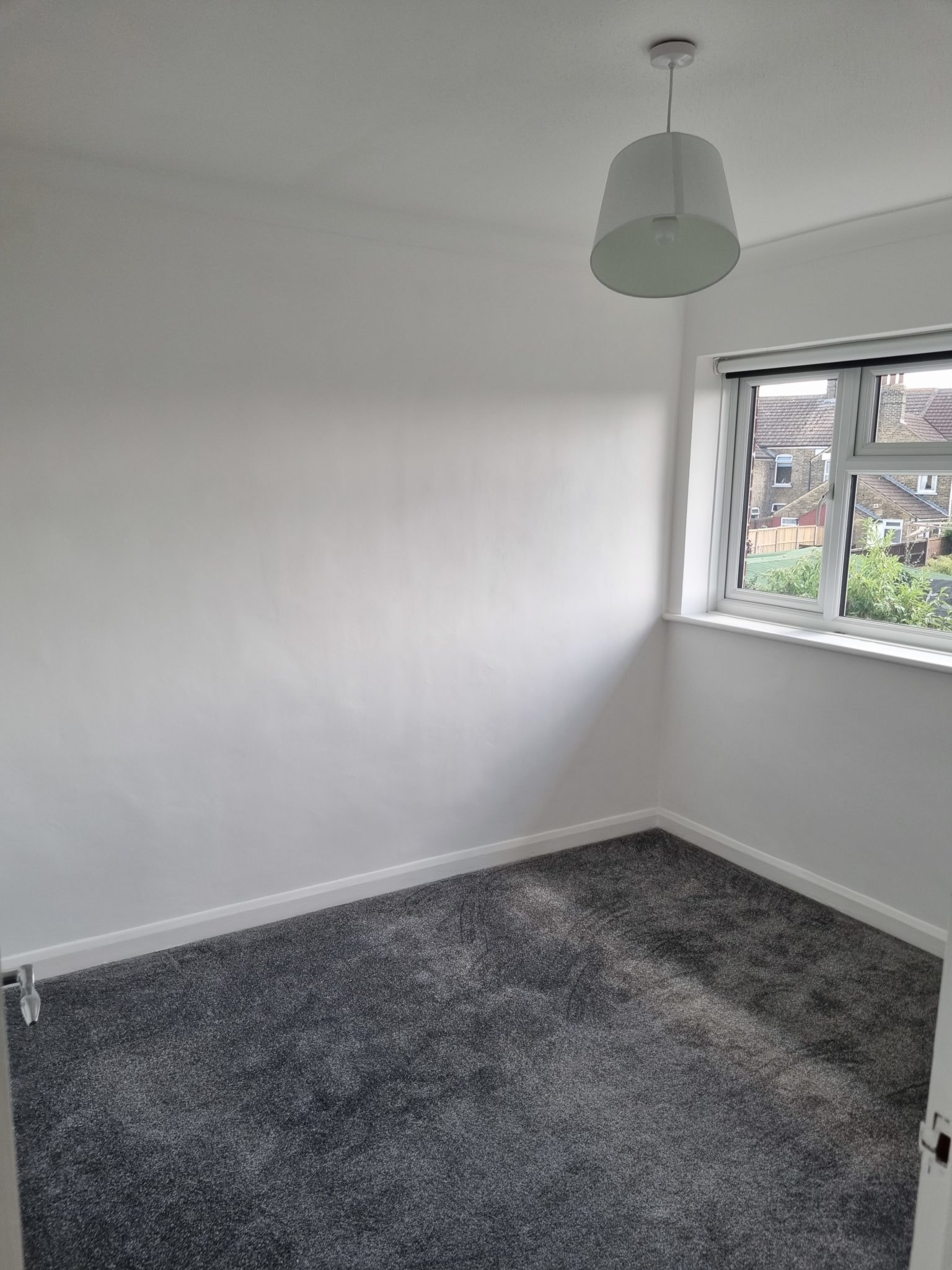 White painted bedroom with a grey carpet