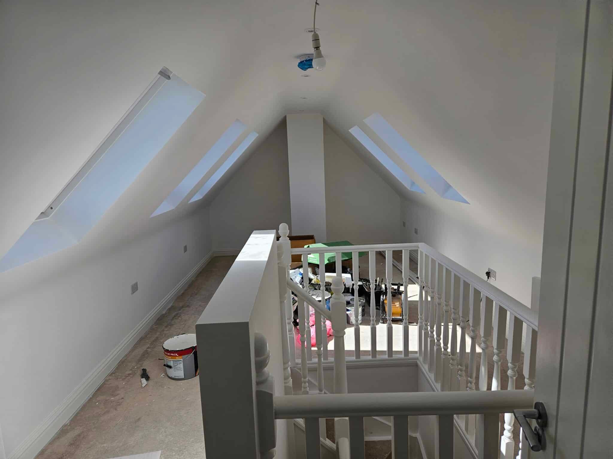Loft landing with roof windows and white painted spindles