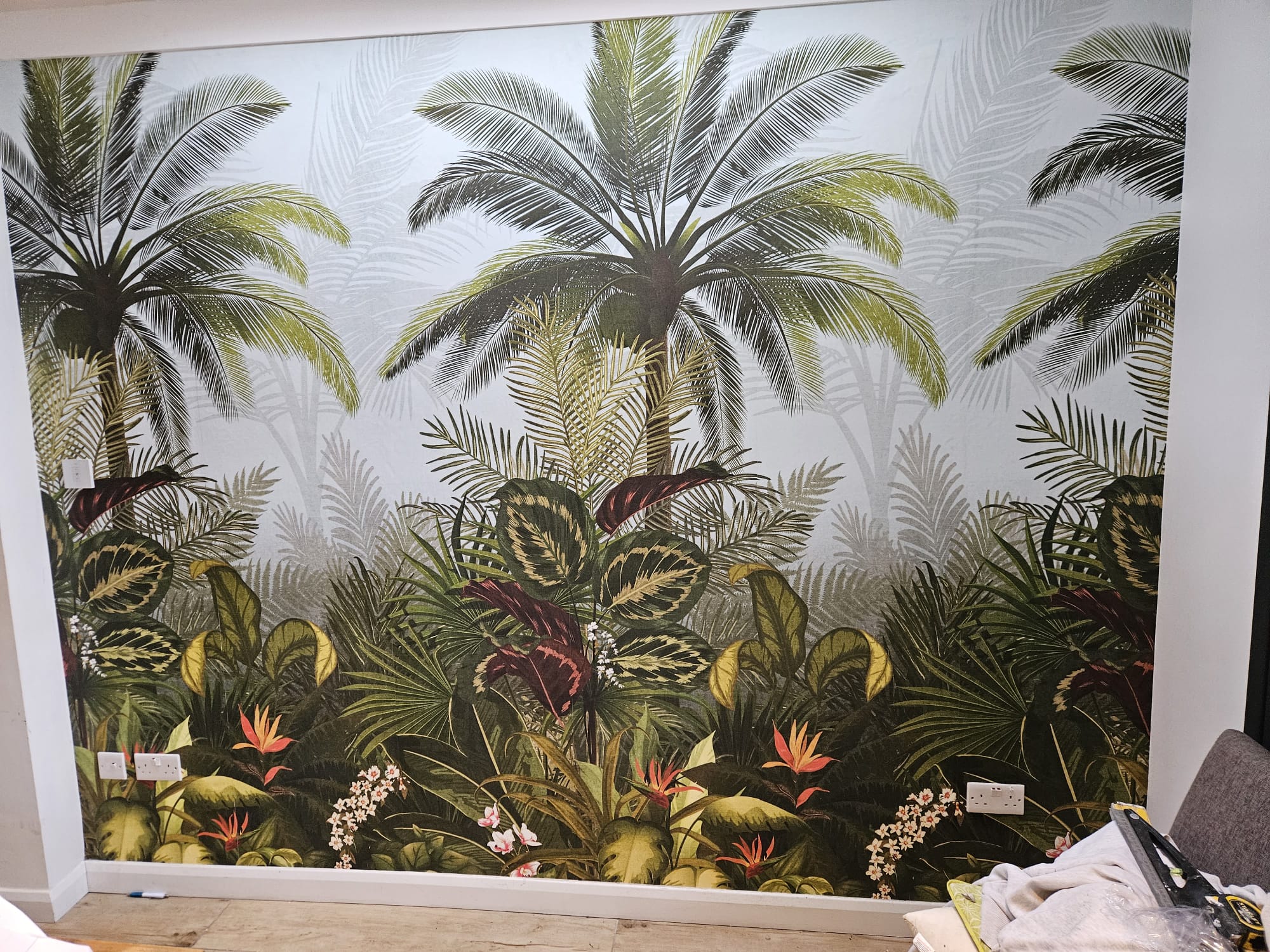 Wall papered in a tropical palm tree mural